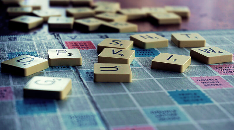 Closeup of Scrabble pieces used to create words and sentence types